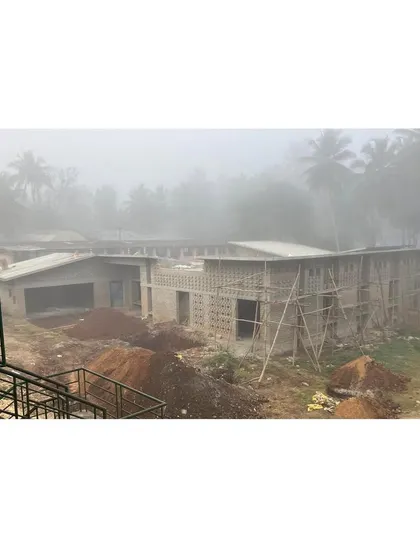 An early morning view of the site shrouded in fog. This image captures the building taking shape and settling into its environment, even before completion.