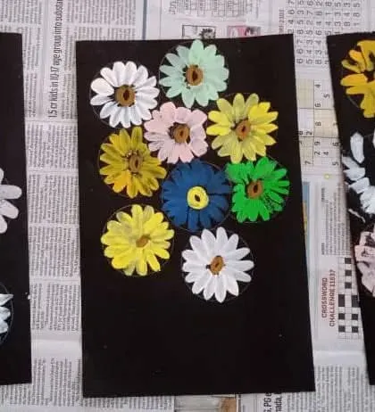 Fork painting is a fun and unconventional way to create beautiful textures. Here, children used forks to paint these vibrant flowers, exploring a new tool for their artistic expression.