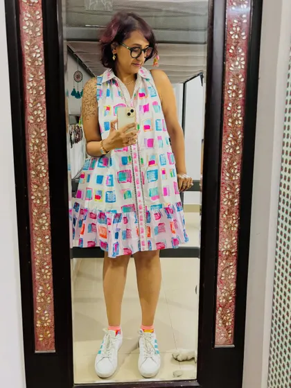 Kicking off the weekend in this vibrant, free-flowing dress. I love pairing colorful outfits with simple white sneakers for a playful, casual look.