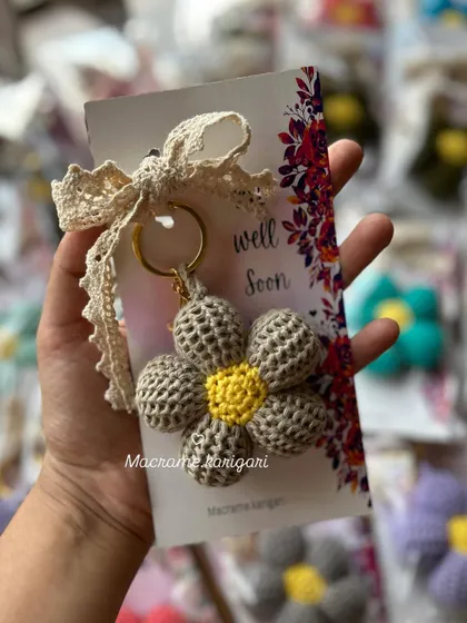 A "Well Soon" puff flower keychain, designed to bring a little cheer to someone who needs it. It's a small, heartfelt gesture to show you care.