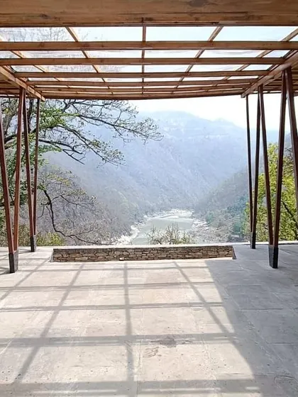 **Angling Centre, Pancheshwar:** The structure is designed to feel light and connected to its surroundings. The translucent roof allows for diffused sunlight, creating a shaded but bright space for anglers and visitors to rest and enjoy the view.