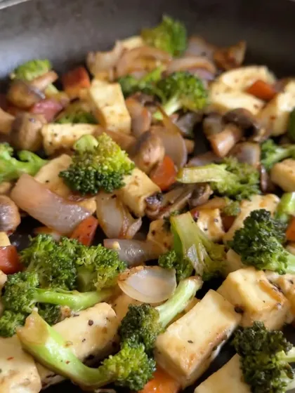 A high-protein, low-carb vegetarian stir-fry with paneer, broccoli, mushrooms, and onions in a spicy garlic-chili sauce.