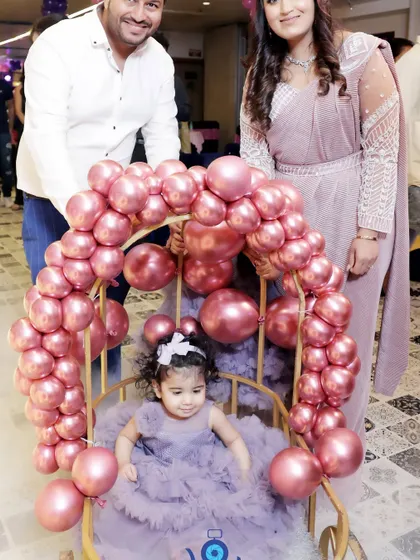 The birthday girl makes her entrance in a special chair decorated with pink balloons. Capturing these unique, planned moments is a key part of my event photography service.