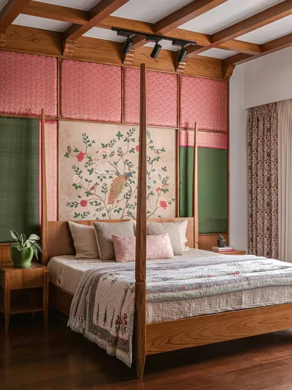 A full view of the four-poster bed and its elaborate, ceiling-height headboard, showcasing the rich layers of material and texture.