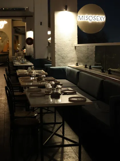 An atmospheric shot of the lounge's outdoor seating area at dusk, showcasing the modern and sophisticated setup before the party begins.