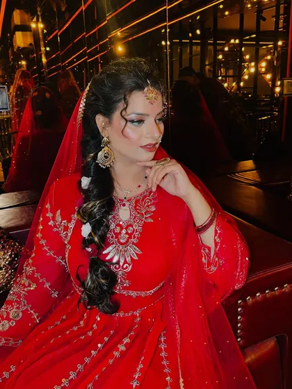 A classic pose showing the bride's side profile. The lighting catches the highlighter on her cheekbones, emphasizing the glowing skin finish that I am known for creating.