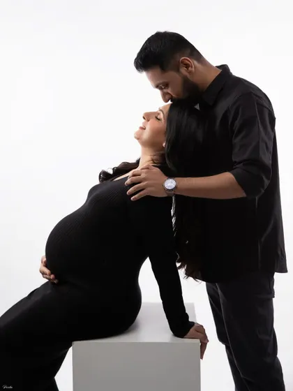 A beautiful, high-contrast portrait of a couple sharing an intimate moment. The focus is entirely on their connection.