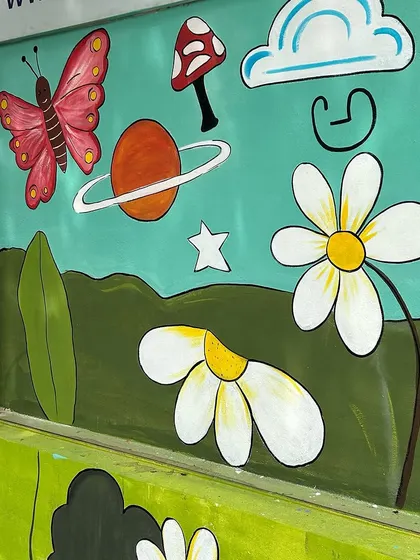 Planets, butterflies, and mushrooms are scattered across this section, creating a whimsical scene for the kids to explore.