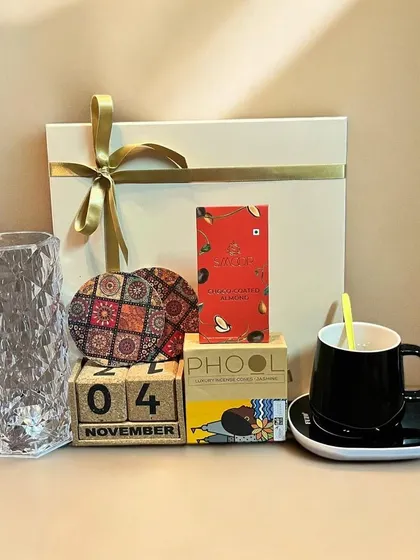 An ideal Diwali gift combo for employees or clients. This set includes a desk calendar, a mug, incense from Phool, and other thoughtful items presented in a simple, elegant gift box.