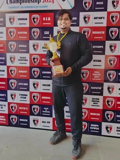 The coach with the team's trophy, celebrating another victory for NMFA at the Vifa Cup.