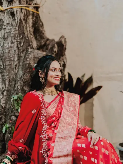 Elegance personified. This bride's red saree look for her engagement is timeless. We went for a soft, glowing makeup look with a half-up hairstyle to keep it classic and chic.