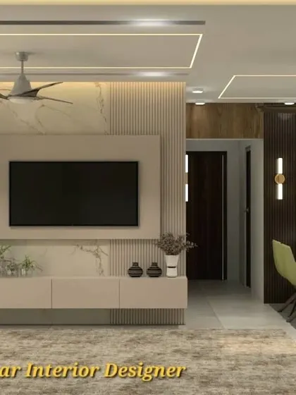 A bright and airy living room with a marble-clad TV wall and a light-colored floating console. The design is complemented by a pooja unit with a CNC-cut door.