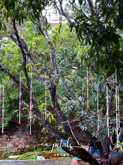 A duplicate image of the romantic floral streamers hanging from the trees.