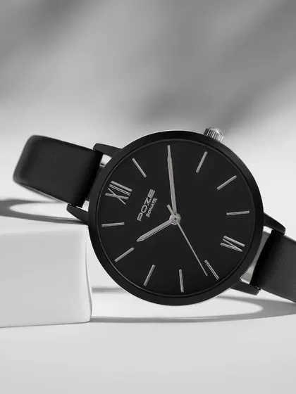 A classic black Sonata watch styled in a high-contrast black and white setting. The sharp lines of the props and the dramatic lighting give this shot a sophisticated and timeless feel.