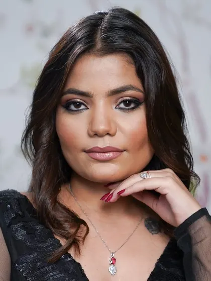 The final pose. This client is radiating confidence after her makeup session, showcasing a beautifully blended smokey eye and flawless complexion.