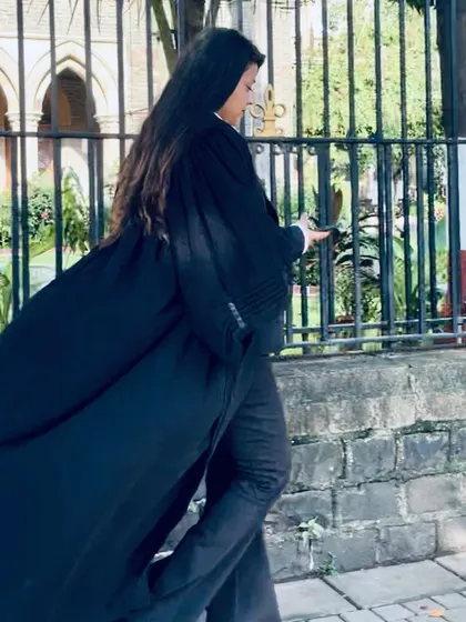 A dynamic shot of me walking past the gates of the Bombay High Court. I am here to conquer challenges and win cases for my clients.