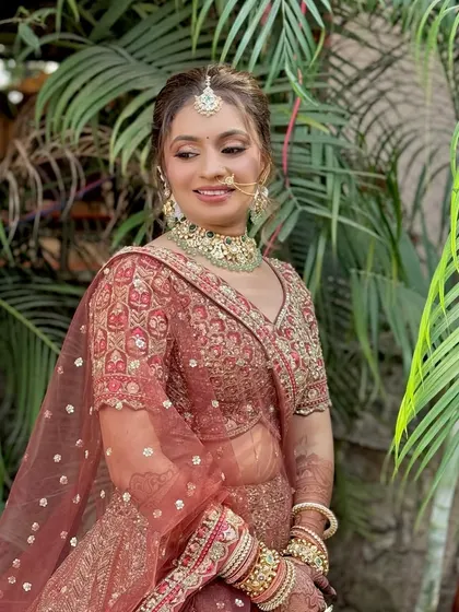 A beautiful candid shot of the bride, showcasing the soft glam makeup in natural outdoor lighting. The look is fresh, radiant, and enhances her features.