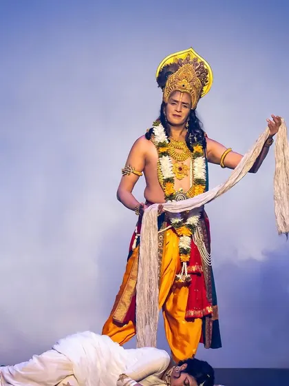 A powerful and symbolic tableau from the story of Draupadi. Staging moments like this requires careful choreography to create a strong visual impact that conveys the entire emotional weight of the scene.