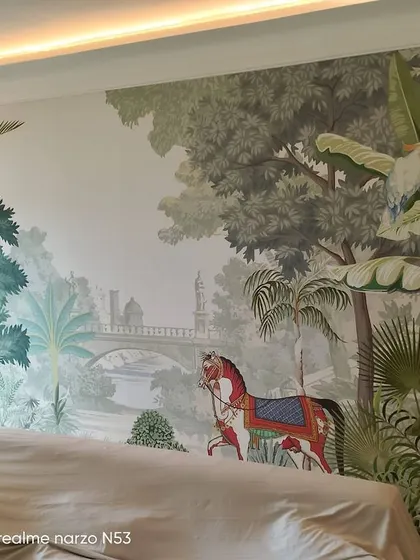 A scenic mural with a mix of Indian and tropical elements, featuring a decorated horse in a lush landscape. This custom piece tells a unique story.