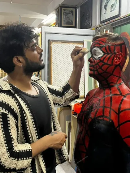 An artist carefully painting the details on the Spiderman mask. This level of precision is what makes the final result so convincing.