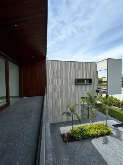 From this balcony at the Rosewood project, the view looks down into the central courtyard. The interplay of wood, stone, and greenery highlights our approach to creating complex, layered facades that are rich in texture and form.