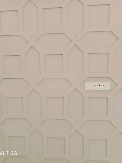 Our smart switches are designed to be discreet. Here, they are installed on a wall with geometric paneling, showing how our products can complement detailed interior design work without being obtrusive.