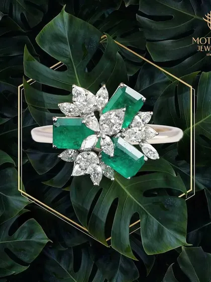 Nature's beauty is captured in this striking ring, where vibrant emeralds are juxtaposed with marquise and pear-shaped diamonds. It is a piece of wearable art for the discerning collector.