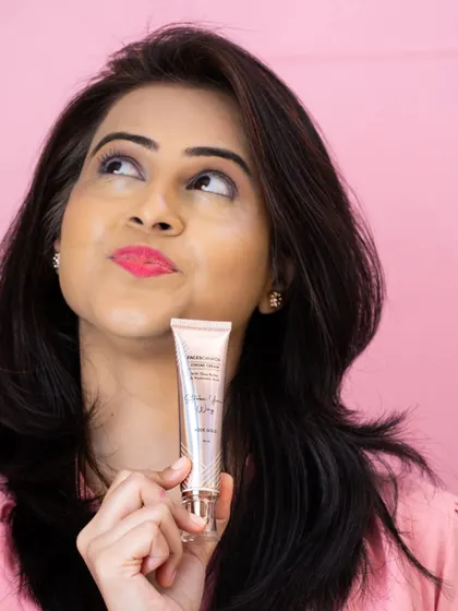 A playful and thoughtful portrait of a model with the skincare product, perfect for a social media campaign.
