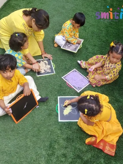 Our toddlers explore drawing on slates with their teacher. Vasant Panchami is a perfect opportunity to introduce them to new tools for creative expression.