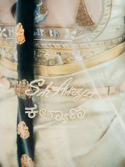 It's the small touches that make an outfit truly yours. For this bride, we embroidered her wedding hashtag in both English and Kannada script onto her veil, making it a unique keepsake of her special day.