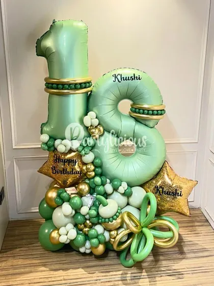 An elegant 18th birthday balloon bouquet in shades of green and gold, personalized with the name 'Khushi'.
