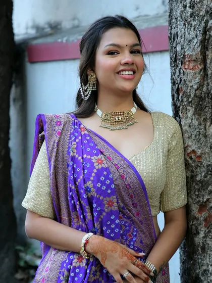 A close-up of my own Kankotri look. I chose a gold choker and a shimmery blouse to go with my purple saree, keeping the makeup fresh and glowy.