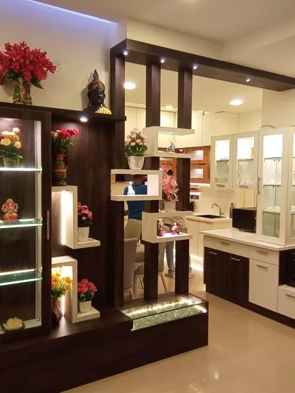 This living and dining area partition is designed for both separation and display. The dark wood structure with illuminated white shelves provides a beautiful showcase for decor while maintaining an open feel.