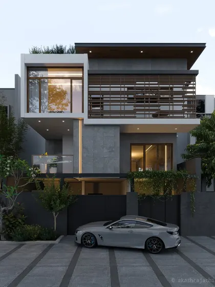 A high-end contemporary residence in Bangalore, featuring a dark fence for privacy and a complex facade with multiple materials and layers.
