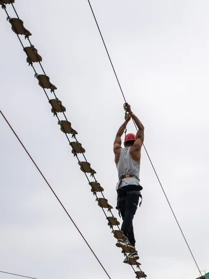 Another shot of a staff member conquering the rope bridge, demonstrating the spirit of challenge and teamwork we encourage.