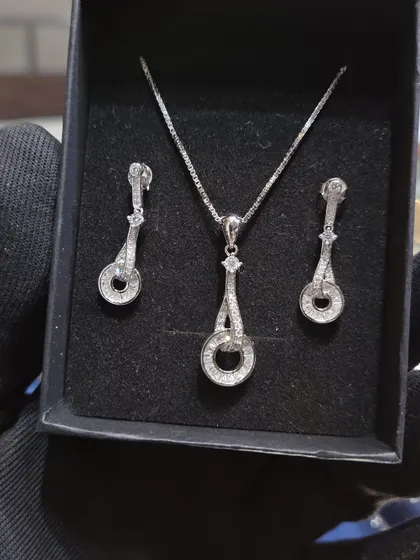 Another beautiful silver pendant set. This one features a classic design with sparkling stones, perfect for any occasion.