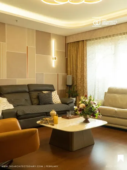 Inspired by Korean minimalism, this living and dining area uses a calm, neutral palette with clean lines and geometric patterns on the wall. The focus is on creating a serene and uncluttered environment with sophisticated lighting.
