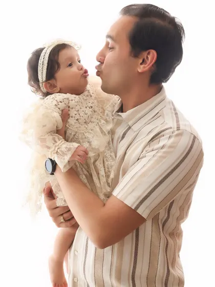 A sweet, puckered-up kiss between a father and his baby. This adorable and funny moment perfectly captures the love and lightheartedness of fatherhood.