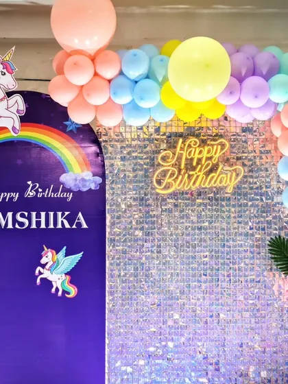 The personalized backdrop and sequin wall for Hamshika's unicorn party.