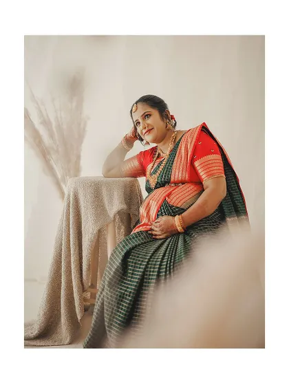 A thoughtful moment captured during her maternity shoot. The natural makeup look ensures she feels comfortable and looks like the best version of herself.