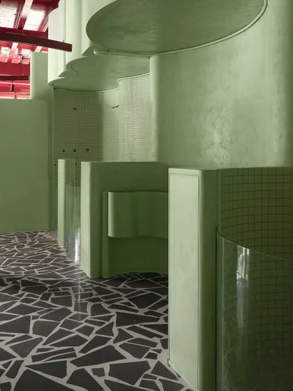 The reflection on the polished terrazzo floor adds another layer of depth and sophistication to the interior.
