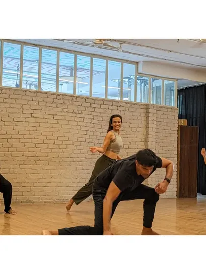 A group of dancers moves in sync, demonstrating the shared energy and focus that defines our X-Sense classes.
