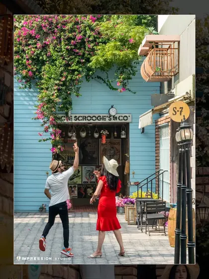 A playful and dynamic shot in a colorful, European-style street set. Their movement and laughter bring the scene to life, creating a photo that is both fun and visually interesting.