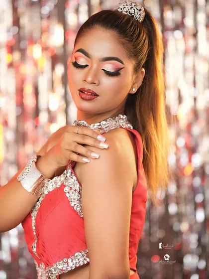 A soft, glamorous pose that showcases the blended eyeshadow and glossy red lip.