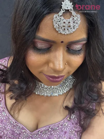 A close-up of the glittery lavender eye makeup, a popular choice for evening wedding events.
