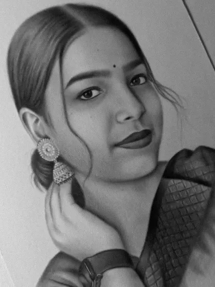 A close-up of a finished portrait, highlighting the jhumka earring and soft expression.