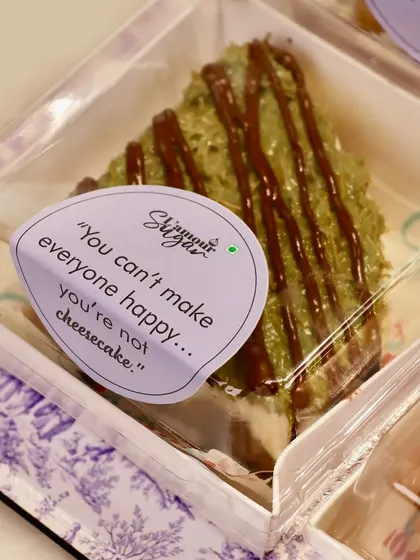 "You can't make everyone happy... you're not cheesecake." Another one of our fun messages, attached here to a slice of our creamy kunafa cheesecake, part of our indulgent Rakhi collection.