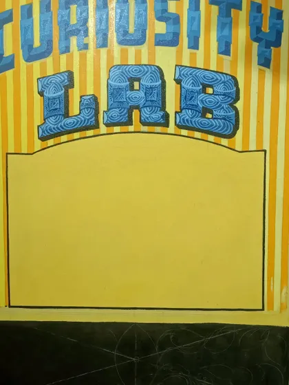 A work-in-progress shot of the "Curiosity Lab" sign. The letters are filled with intricate patterns, and the space below is marked for additional design elements.
