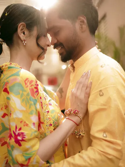 An intimate, sun-kissed moment between the couple during their Haldi, filled with warmth and happiness.