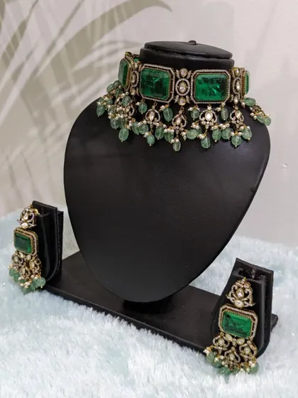 This Victorian choker with large, emerald-colored stones and strawberry beads is a bold and beautiful statement piece.